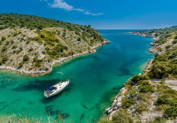 sail boat navegating in a blue sea