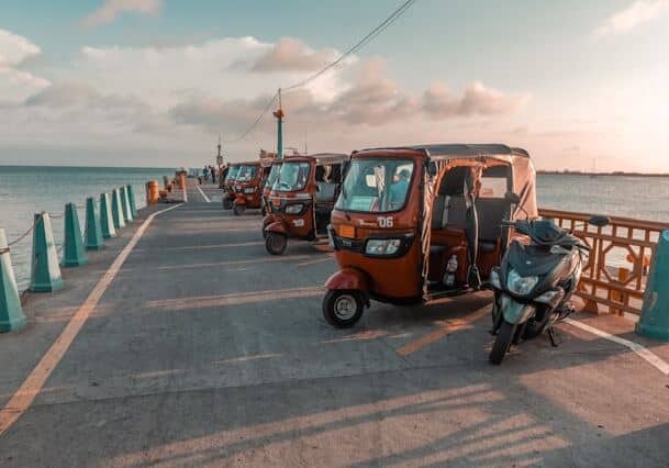 A row of three wheelers parked next to each other on a pier in Honduras - citizenship by marriage