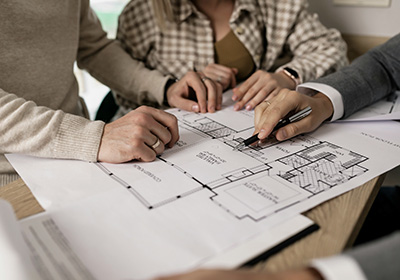 people analysing a floorplan in a real estate meeting