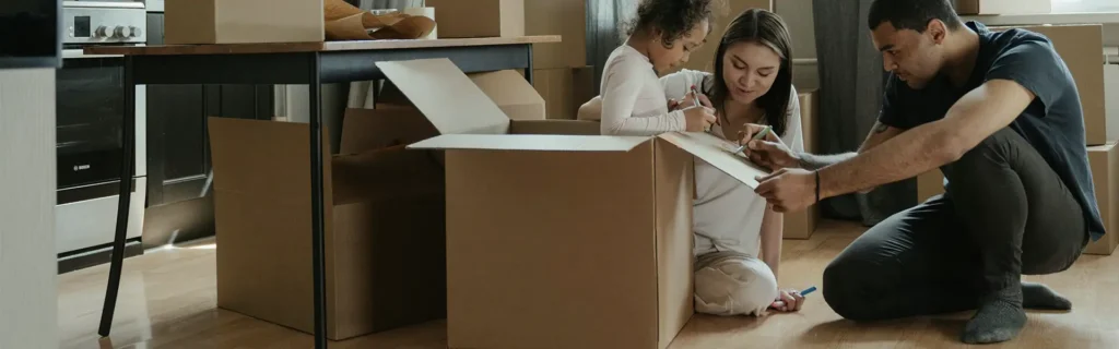 Family between boxes moving to Portugal