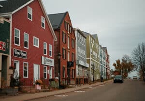 A row of houses on a street of Charlottetown with a car parked