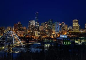 a bridge over a river with Edmonton city in the background
