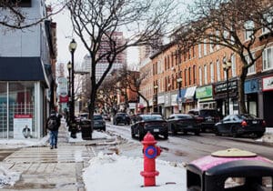 a red fire hydrant sitting on the side of a snow-covered street in Hamilton