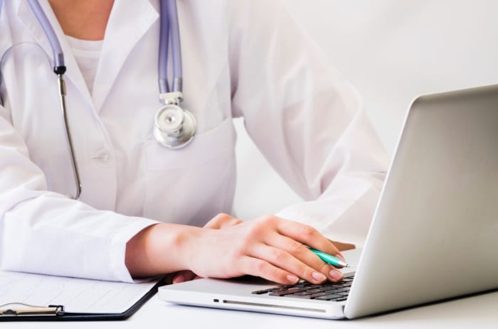 medical professional on a laptop provide healthcare in nauru