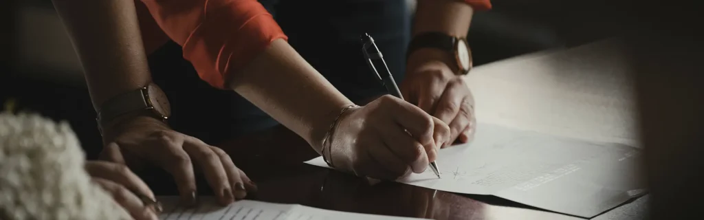 people signingn documents for the cyprus yellow slip application process