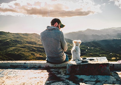 man and dog on a hiking scenario
