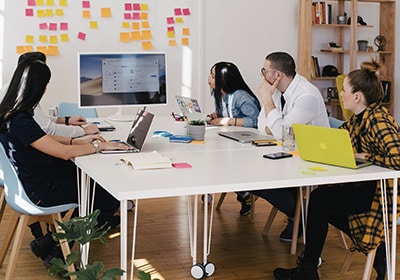 People sitting at a table in an office working in Canada