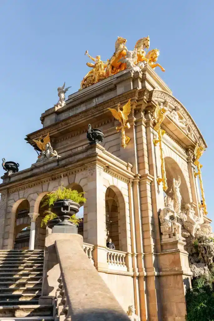 A large building featuring multiple statues adorning its exterior, showcasing intricate designs and artistic details.
