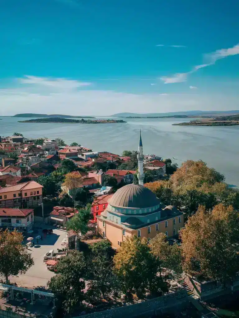 Aerial view of a town featuring a mosque and a church, showcasing the blend of cultural architecture.