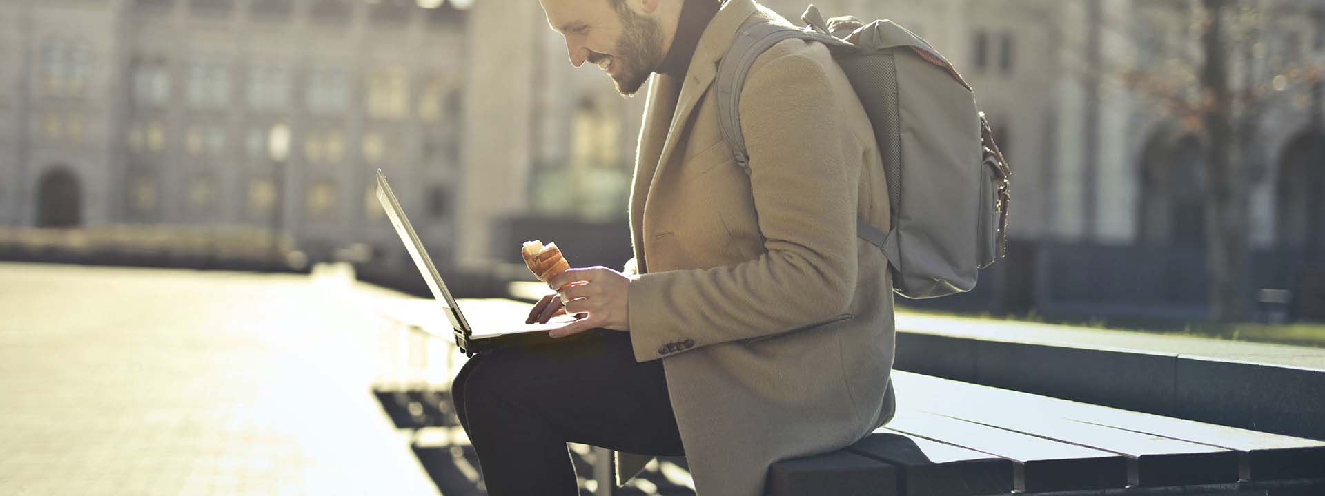 italy digital nomad visa holder on a laptop outside
