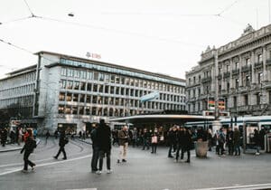 People walking around in front of a UBS bank branch - best global banks