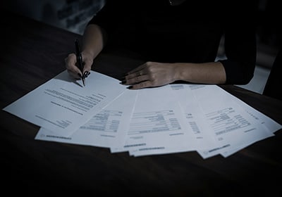 A woman sitting at a table with documents