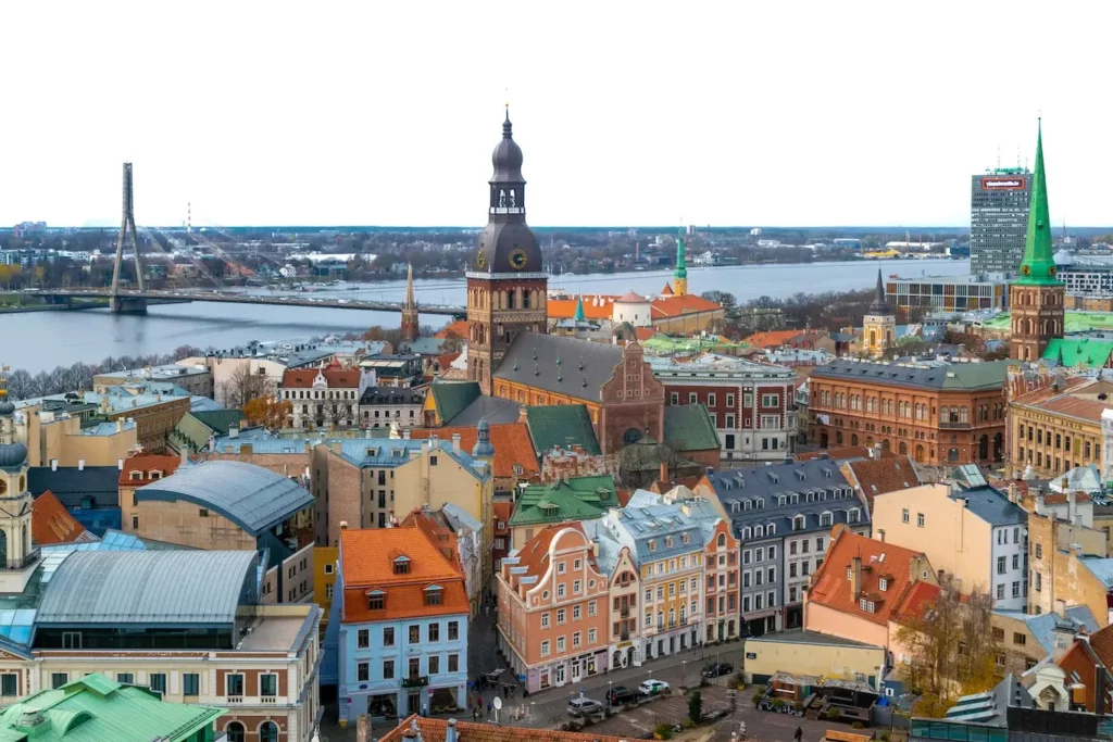 A panoramic view of Riga, Latvia, showcasing its historic architecture and vibrant cityscape under a clear blue sky.
