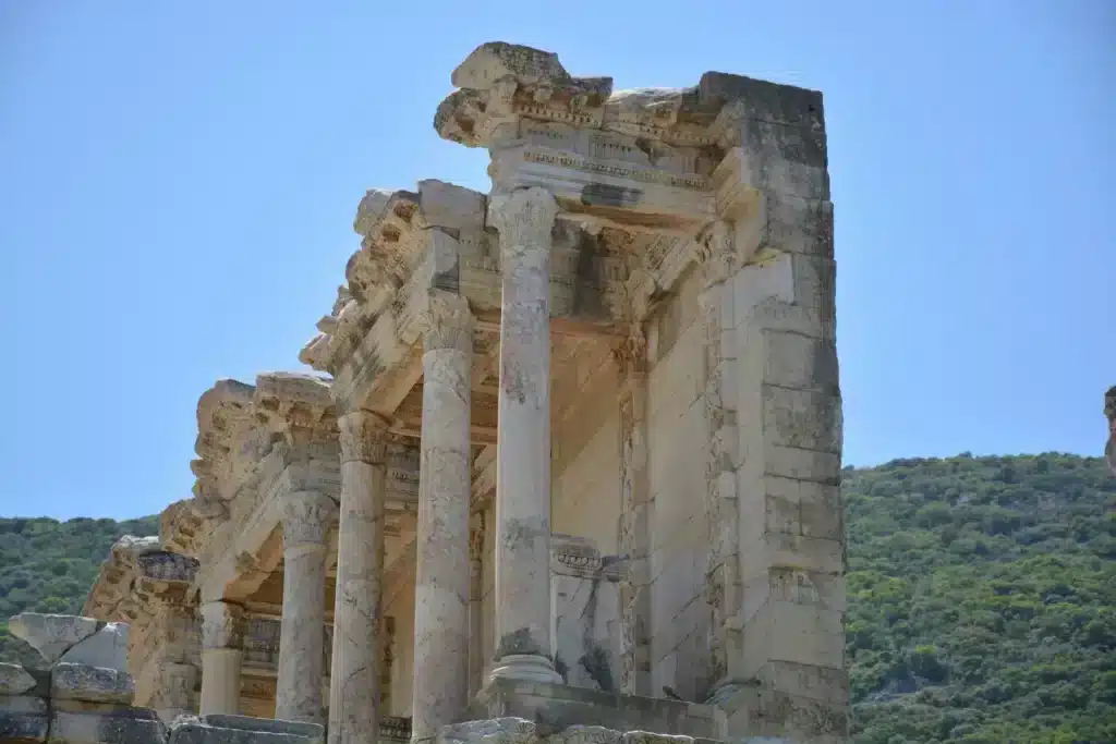Ruins of Ephesus in Turkey, showcasing ancient columns and structures under a clear blue sky.