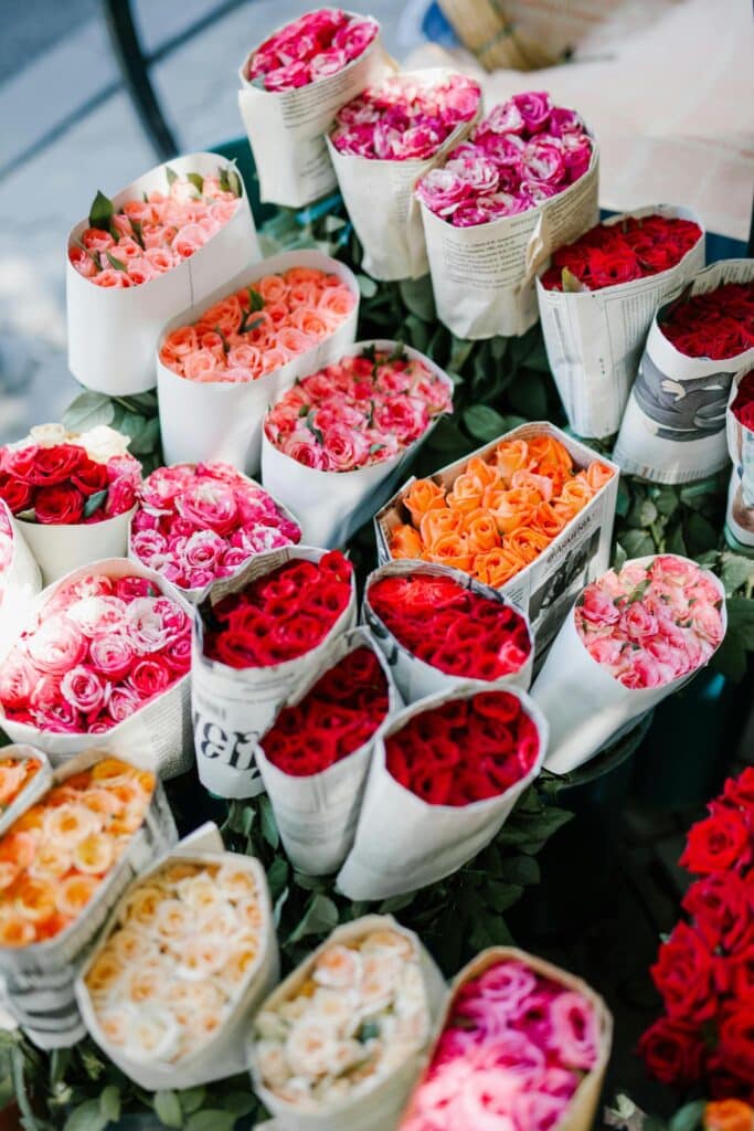 A vibrant flower market in Paris, France, filled with colorful blooms and bustling shoppers.