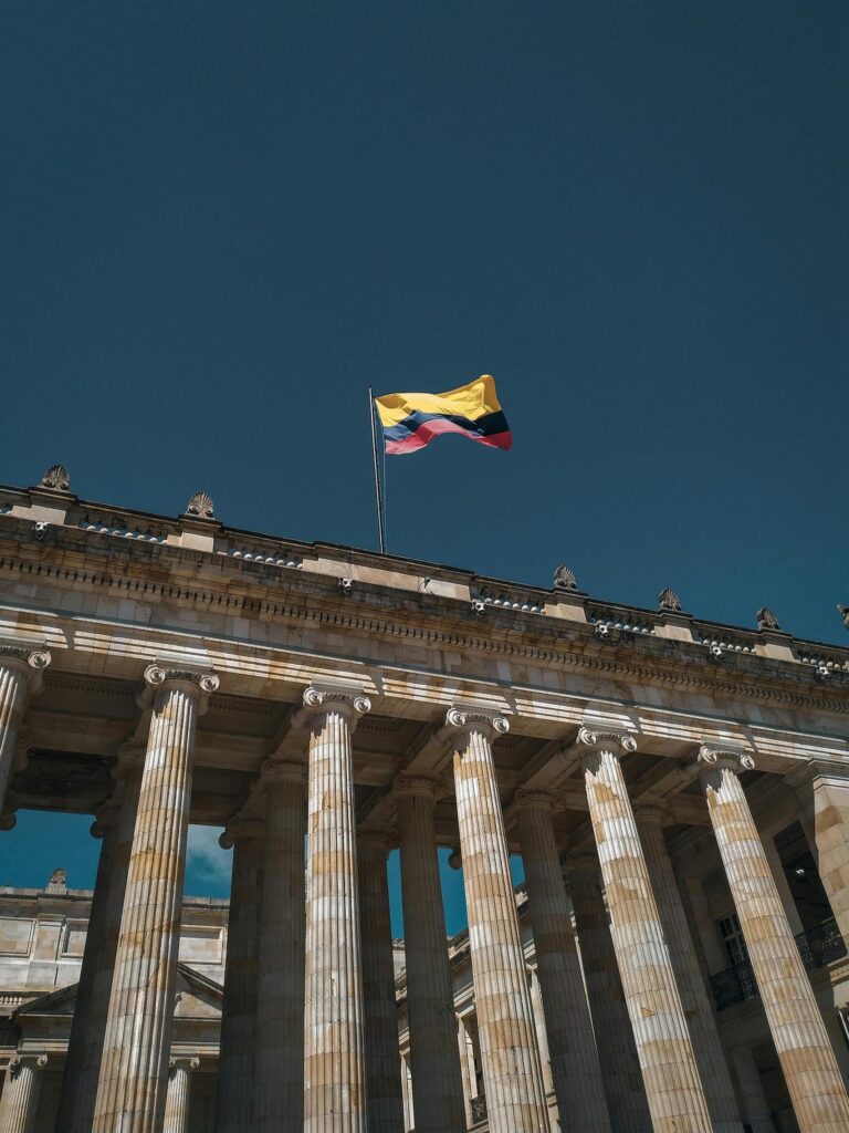 Colombian flag waving on the roof of the parliament building in Berlin, symbolizing diplomatic presence.