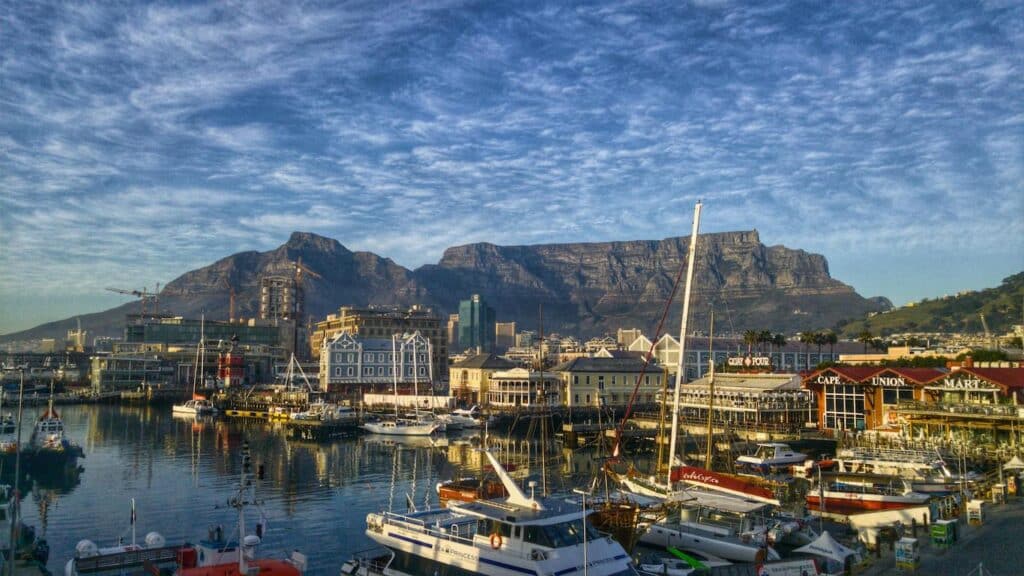 Cape Town skyline viewed from the harbor, showcasing its iconic Table Mountain and vibrant cityscape.
