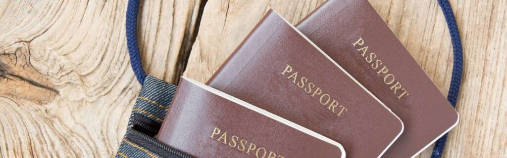 dual passports on a wooden table inside a bag