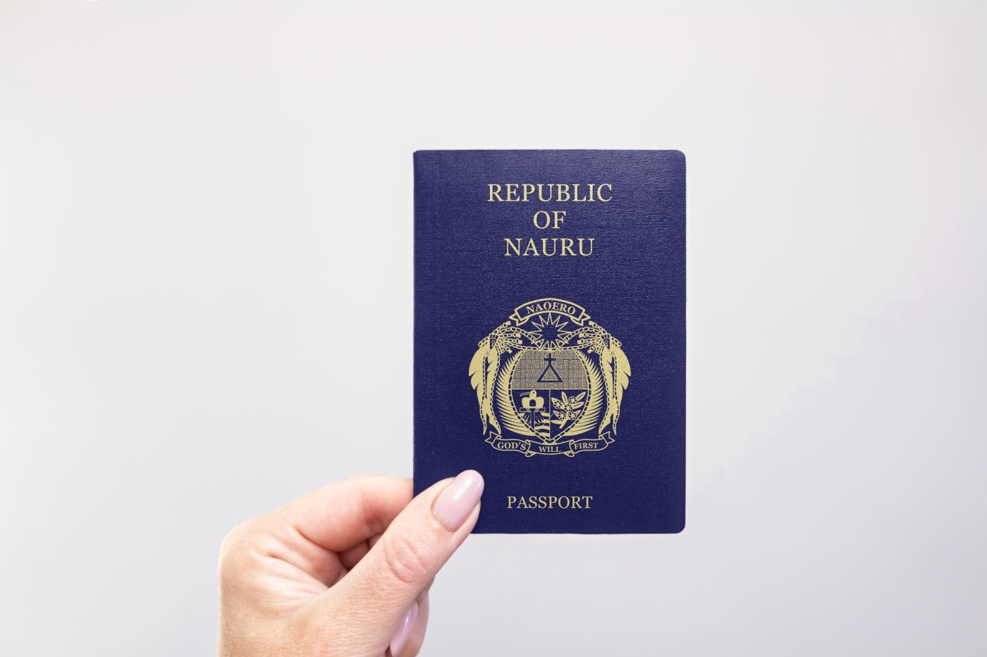 person holding a nauru passport against a white background