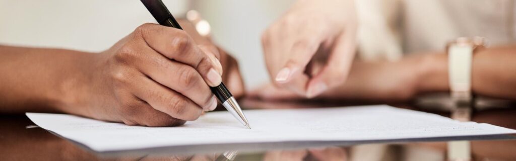 person signing papers to apply for grenada citizenship by investment