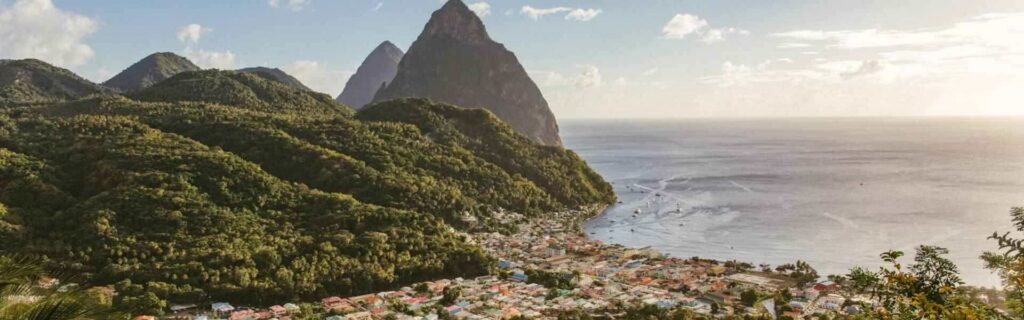 scenic view of a small town and piton peaks in st lucia