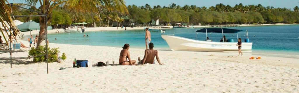 tourists sitting on a beach in grenada