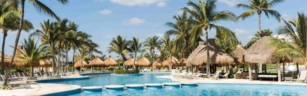 large pool area and a bridge and palm trees at a st lucia hotel