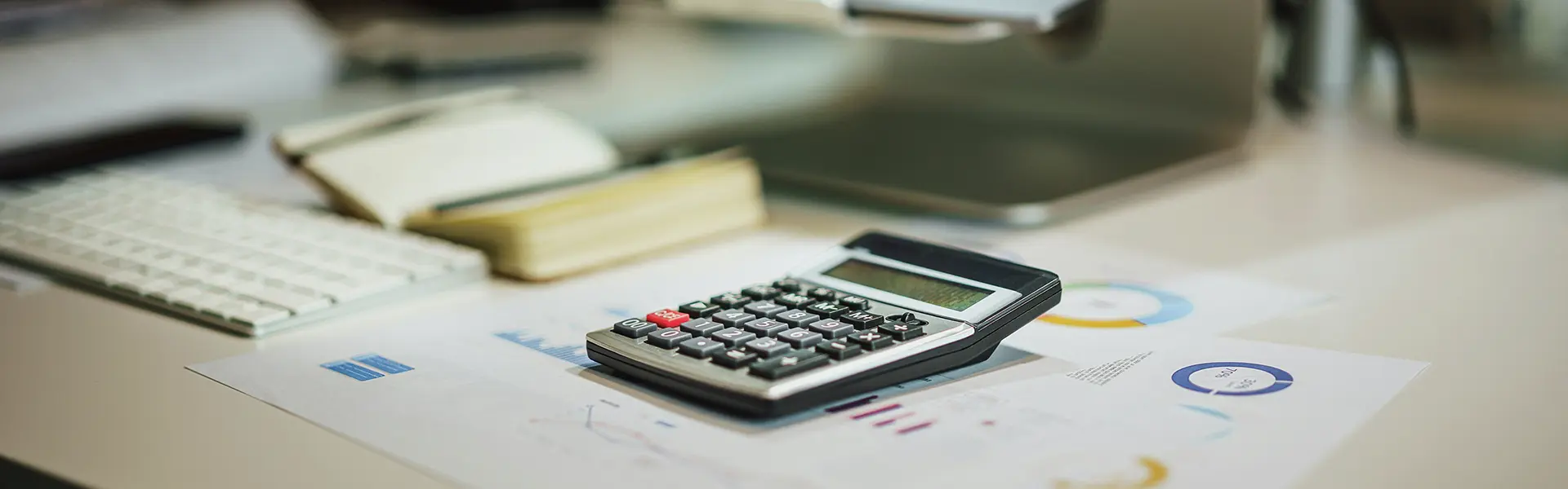 calculator, computer and sheets on taxes