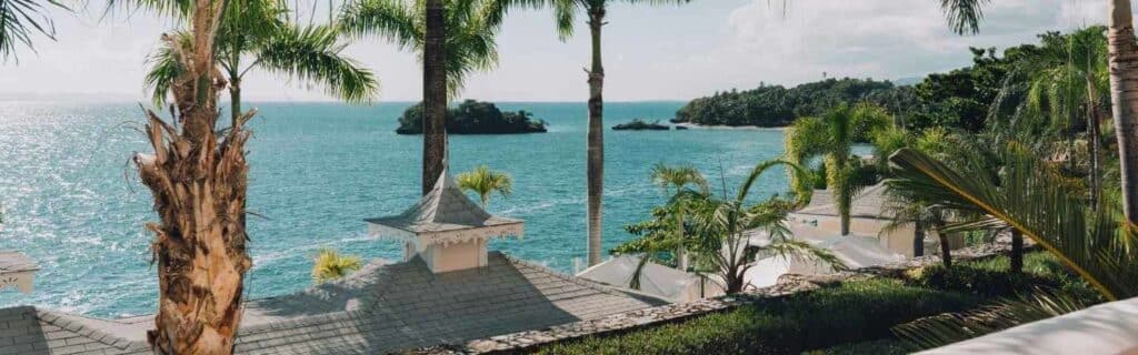 cliff-side hotel in grenada overlooking the ocean and a bright sky
