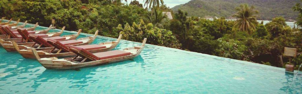 infinity pool at a dominica hotel with greenery in the distance