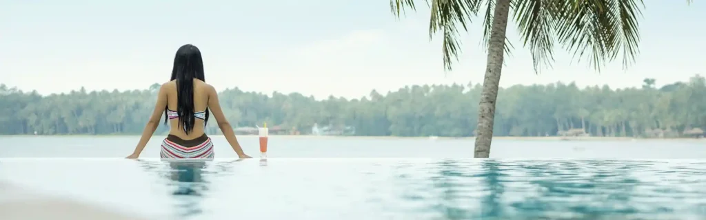 woman sit by the pool on a resort