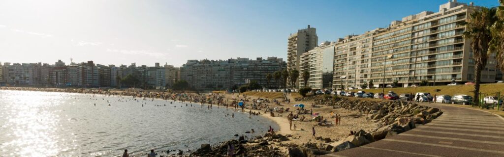 beach bay with people swimming in montevideo, uruguay