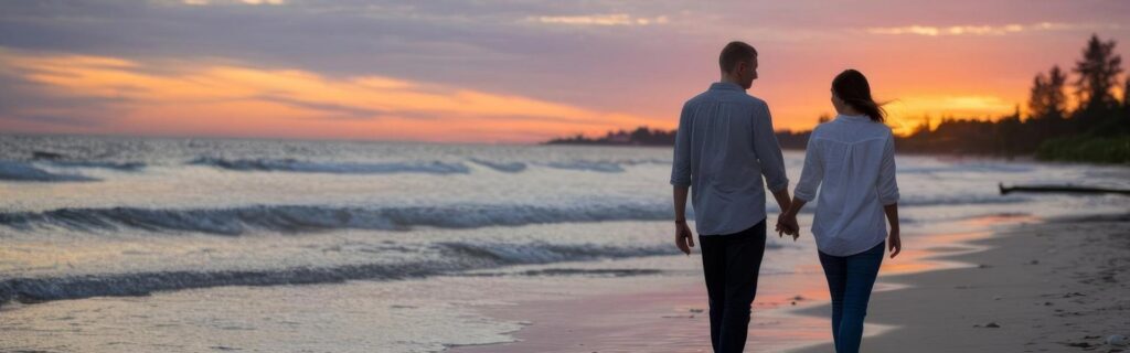 couple walking on the beach into the sunset