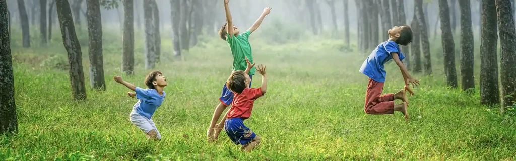 Children playing in a forest in latvia