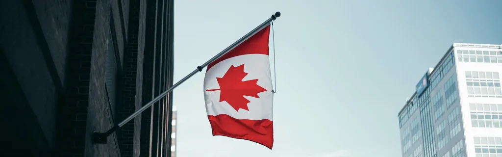 canada flag with buildings on the background